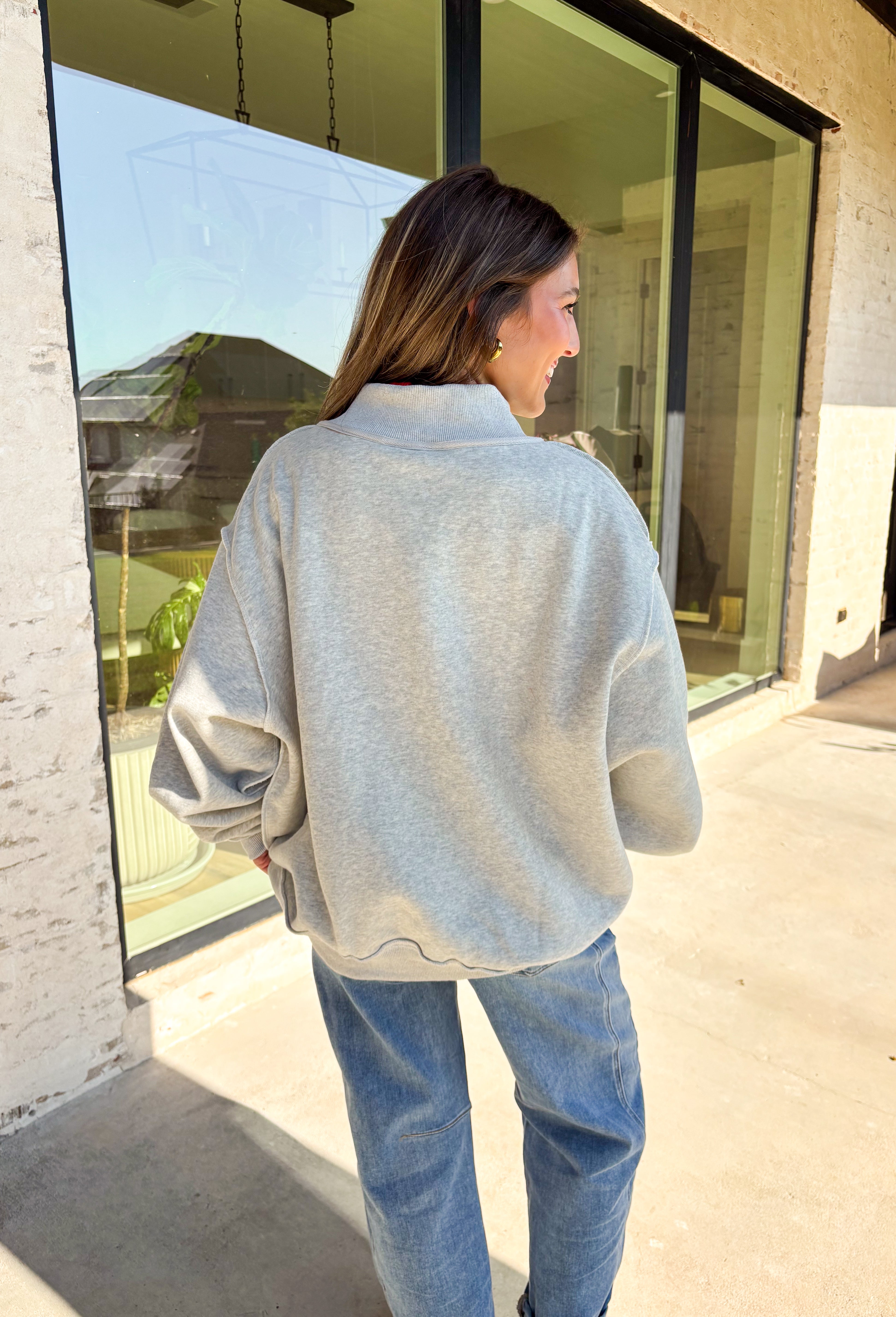 Two moods, one cozy pullover. This reversible mock neck sweater gives you options with light gray on one side and soft white fleece on the other. Printed in hunter green, one side reads “Gym” while the reverse says “Bed,” letting you wear your vibe for the day. With its oversized fit and cozy texture, it’s the perfect piece for lounging, layering, or heading out in casual comfort.