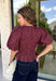 Add a playful touch to your fall wardrobe with this charming top from Entro. Designed in a rich plum hue with a light pink polka dot print, this feminine blouse is both timeless and fun. The smocked bodice creates a flattering, comfortable fit, while the puff sleeves add the perfect touch of romantic charm. Crafted from breathable cotton, this versatile top is easy to dress up for work or pair with denim for an effortless everyday look.