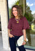 Add a playful touch to your fall wardrobe with this charming top from Entro. Designed in a rich plum hue with a light pink polka dot print, this feminine blouse is both timeless and fun. The smocked bodice creates a flattering, comfortable fit, while the puff sleeves add the perfect touch of romantic charm. Crafted from breathable cotton, this versatile top is easy to dress up for work or pair with denim for an effortless everyday look.