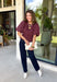 Add a playful touch to your fall wardrobe with this charming top from Entro. Designed in a rich plum hue with a light pink polka dot print, this feminine blouse is both timeless and fun. The smocked bodice creates a flattering, comfortable fit, while the puff sleeves add the perfect touch of romantic charm. Crafted from breathable cotton, this versatile top is easy to dress up for work or pair with denim for an effortless everyday look.