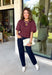 Add a playful touch to your fall wardrobe with this charming top from Entro. Designed in a rich plum hue with a light pink polka dot print, this feminine blouse is both timeless and fun. The smocked bodice creates a flattering, comfortable fit, while the puff sleeves add the perfect touch of romantic charm. Crafted from breathable cotton, this versatile top is easy to dress up for work or pair with denim for an effortless everyday look.