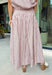 Soft pink meets warm brown in this charming midi skirt from Day + Moon. Featuring a classic stripe print, this feminine skirt brings a fresh pop of color to your fall wardrobe while still feeling easy and versatile. A zipper closure creates a clean, polished finish, while the midi length makes it perfect for everything from workdays and brunch dates to seasonal gatherings.