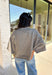 Cozy with a modern edge, this charcoal brown sweater is an easy go-to for cooler days. Designed with a mock neck and cropped length, it’s finished with exposed seam details that add a casual, laid-back vibe. Ribbed cuffs and hem bring structure to the soft knit, while the lightweight blend makes it perfect for layering. A versatile piece that pairs effortlessly with denim, skirts, or wide-leg pants for fall.