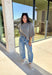 Cozy with a modern edge, this charcoal brown sweater is an easy go-to for cooler days. Designed with a mock neck and cropped length, it’s finished with exposed seam details that add a casual, laid-back vibe. Ribbed cuffs and hem bring structure to the soft knit, while the lightweight blend makes it perfect for layering. A versatile piece that pairs effortlessly with denim, skirts, or wide-leg pants for fall.