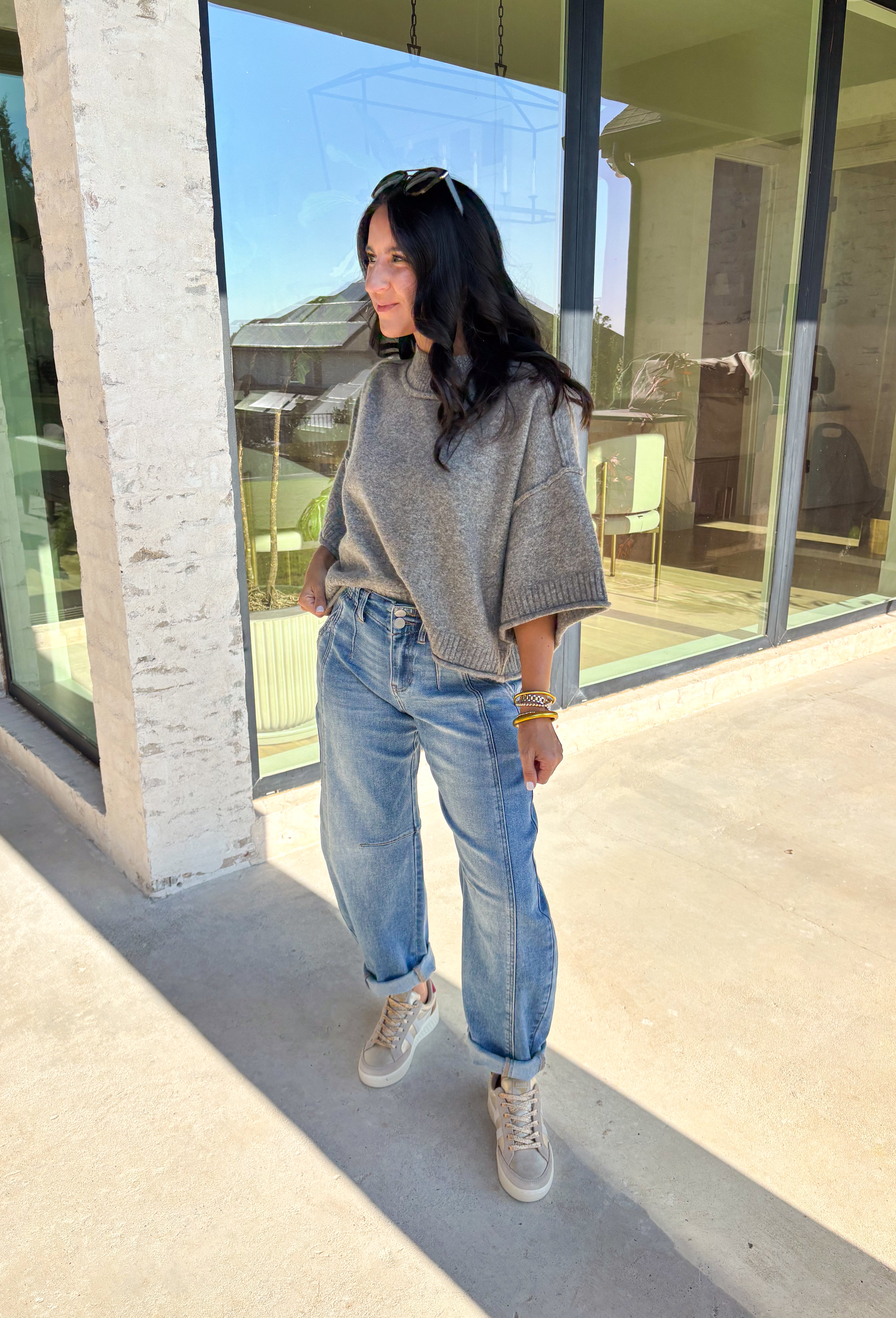 Cozy with a modern edge, this charcoal brown sweater is an easy go-to for cooler days. Designed with a mock neck and cropped length, it’s finished with exposed seam details that add a casual, laid-back vibe. Ribbed cuffs and hem bring structure to the soft knit, while the lightweight blend makes it perfect for layering. A versatile piece that pairs effortlessly with denim, skirts, or wide-leg pants for fall.