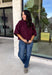 Rich wine color meets cozy knit texture in this short sleeve sweater from &amp; Merci. The deep seasonal shade makes it an easy way to add a little color to your cooler-weather wardrobe while still pairing beautifully with denim and neutral bottoms. A mock neckline gives it a classic finish, while exposed hems add a relaxed, lived-in touch. Ribbed detailing along the neckline, sleeve cuffs, and hem completes the look and adds extra texture throughout. 