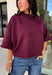 Rich wine color meets cozy knit texture in this short sleeve sweater from &amp; Merci. The deep seasonal shade makes it an easy way to add a little color to your cooler-weather wardrobe while still pairing beautifully with denim and neutral bottoms. A mock neckline gives it a classic finish, while exposed hems add a relaxed, lived-in touch. Ribbed detailing along the neckline, sleeve cuffs, and hem completes the look and adds extra texture throughout. 