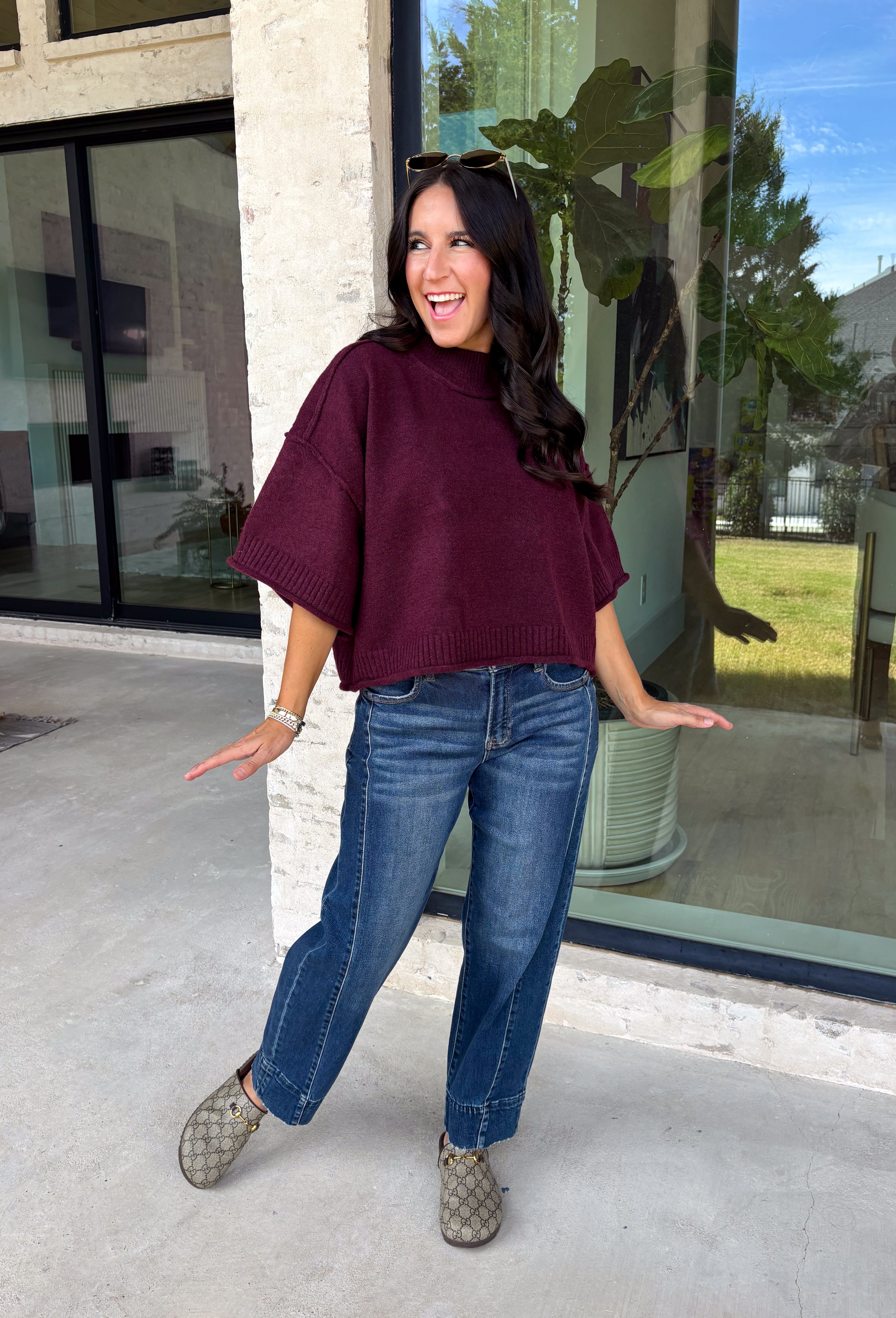 Rich wine color meets cozy knit texture in this short sleeve sweater from &amp; Merci. The deep seasonal shade makes it an easy way to add a little color to your cooler-weather wardrobe while still pairing beautifully with denim and neutral bottoms. A mock neckline gives it a classic finish, while exposed hems add a relaxed, lived-in touch. Ribbed detailing along the neckline, sleeve cuffs, and hem completes the look and adds extra texture throughout. 