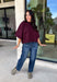 Rich wine color meets cozy knit texture in this short sleeve sweater from &amp; Merci. The deep seasonal shade makes it an easy way to add a little color to your cooler-weather wardrobe while still pairing beautifully with denim and neutral bottoms. A mock neckline gives it a classic finish, while exposed hems add a relaxed, lived-in touch. Ribbed detailing along the neckline, sleeve cuffs, and hem completes the look and adds extra texture throughout. 
