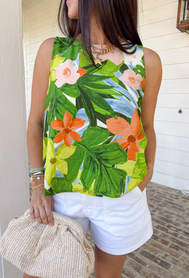 This sleeveless tropical print top is bringing all the vacation-ready energy! With its mix of green palm leaves and vibrant floral tones in blue, pink, orange, and white, it’s the kind of piece that instantly brightens your outfit. The open back detail adds a fun, unexpected twist that feels perfect for warm summer days and nights. Lightweight and breezy, it pairs effortlessly with denim shorts, white jeans, or a flowy skirt. 