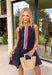 This dark wash denim sleeveless dress is a total spring standout with the sweetest pop of color. The structured denim gives it that classic, timeless feel, while the pink and tomato red trim down the front adds a playful twist. Blue and white stripe trim on either side brings in a fresh contrast that feels perfectly made for sunny days and weekend plans. The sleeveless silhouette keeps it breezy and easy to layer, and the back zipper closure creates a flattering, streamlined fit. 