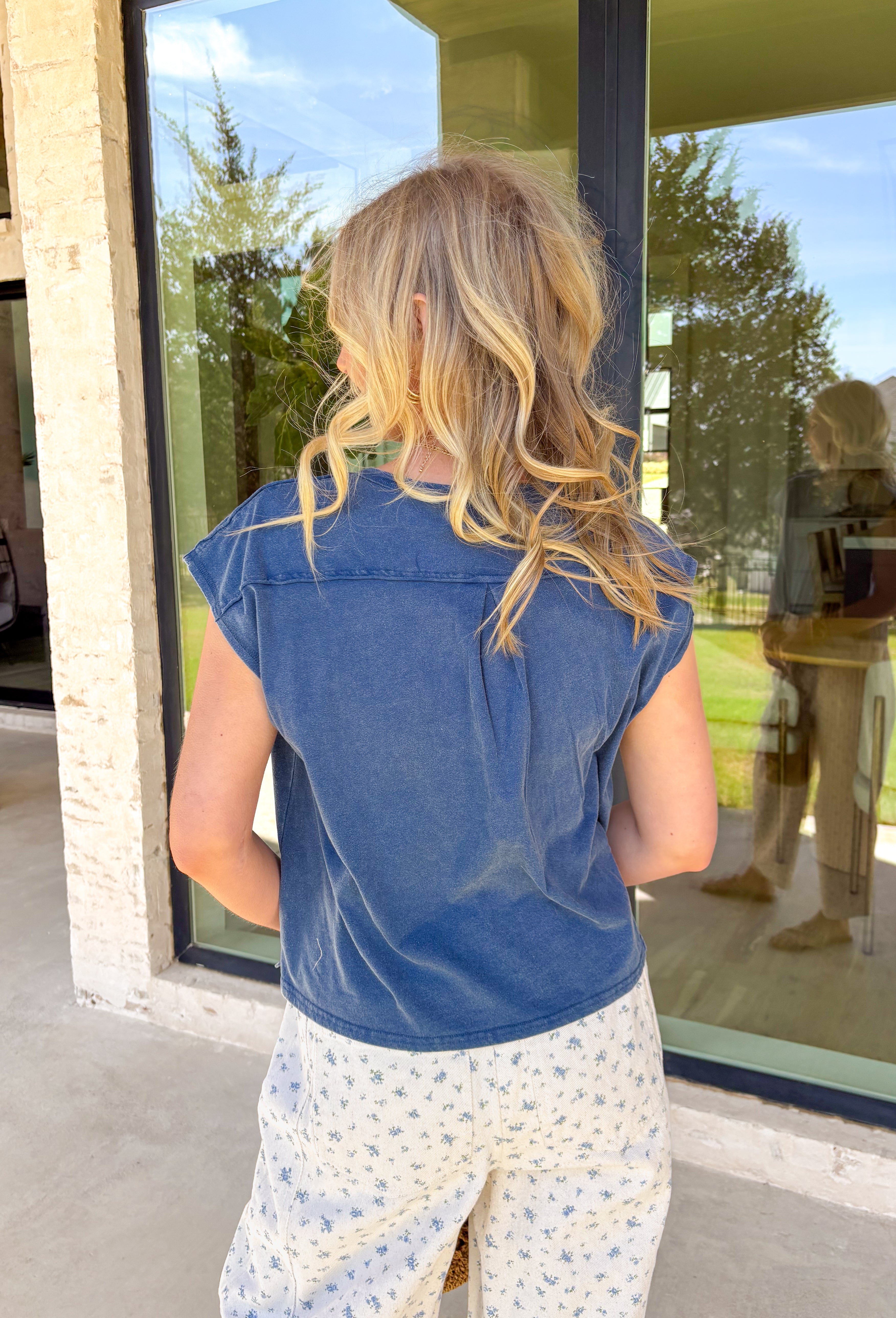 An everyday staple you’ll reach for again and again! This navy short sleeve henley top keeps things simple, classic, and effortlessly comfortable. The henley-style neckline adds a casual, laid-back detail that makes it feel a little more polished than your basic tee. Made from lightweight 100% cotton, it’s breathable and easy to wear all day long. 