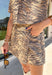 Bring a little wild style to your fall wardrobe with this neutral zebra print skort. Made from 100% cotton denim, it combines the look of a skirt with the easy wear of shorts for a fun piece you can dress up or down. The asymmetric front gives it a modern twist, while the zip-fly button closure and elastic waistband at the back create a comfortable fit. Front pockets and back patch pockets add practical finishing touches. 