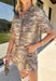 Take a walk on the wild side with this neutral zebra print top from Entro. Made from 100% cotton denim, it gives the classic animal print a fresh, structured feel that's perfect for transitioning into fall. The shirt collar keeps the look classic, while short sleeves and front patch pockets add a casual, laid-back touch. 