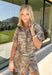 Take a walk on the wild side with this neutral zebra print top from Entro. Made from 100% cotton denim, it gives the classic animal print a fresh, structured feel that's perfect for transitioning into fall. The shirt collar keeps the look classic, while short sleeves and front patch pockets add a casual, laid-back touch. 