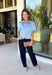 Give your everyday wardrobe a fresh update with this beautifully crafted faux suede top from Day + Moon. Designed in a soft light blue hue, this elevated button-down features a feminine scalloped collar that adds the perfect touch of charm. The short cuffed sleeves and classic button-front design create a polished silhouette that's easy to style for any occasion. 
