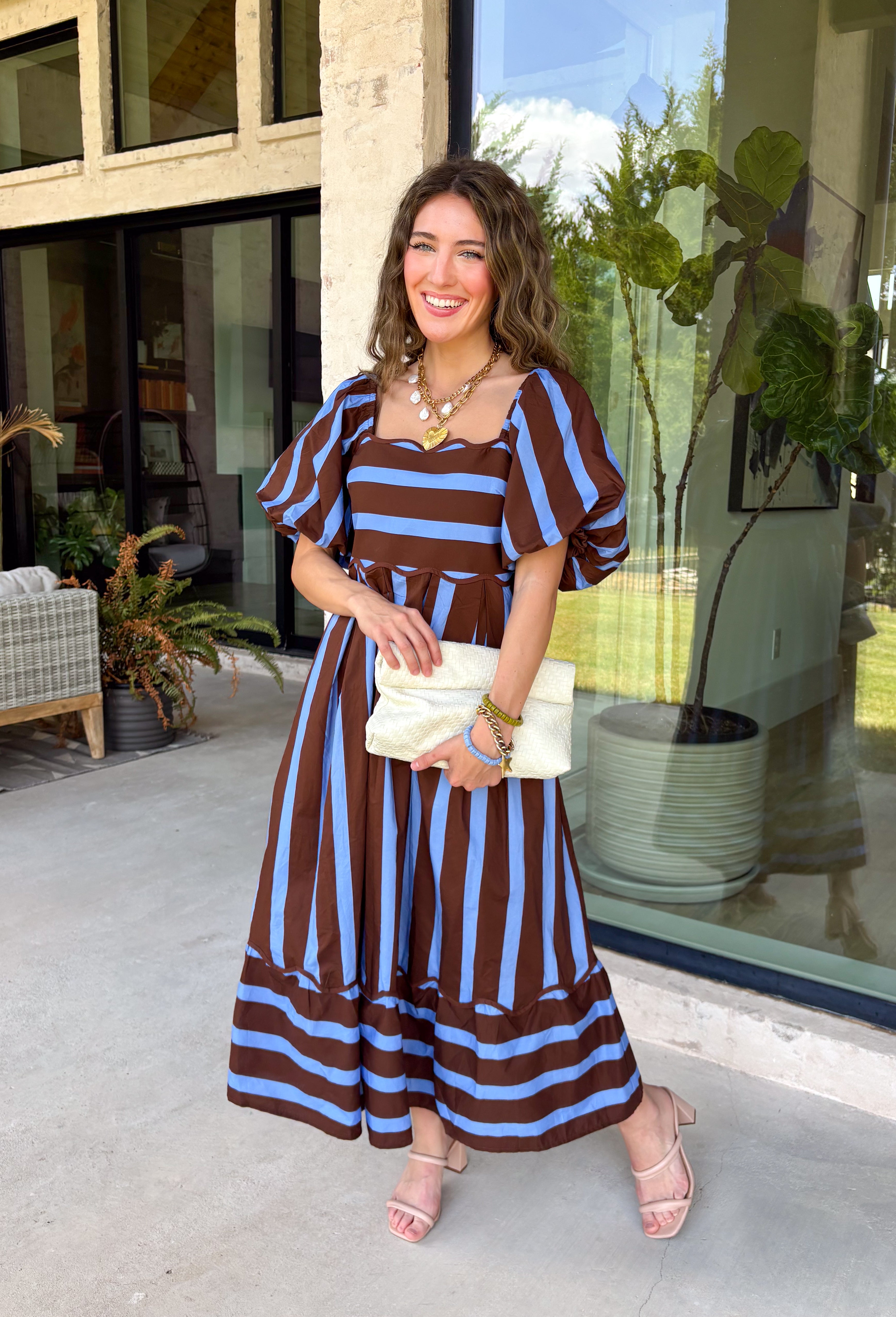 Brown and blue come together in the prettiest way on this striped midi dress from Entro. The scalloped square neckline gives the classic stripe print a sweet, unexpected touch, while short puff sleeves add just the right amount of shape. A smocked back creates a comfortable fit that moves with you, and convenient side pockets make this one even easier to love. 