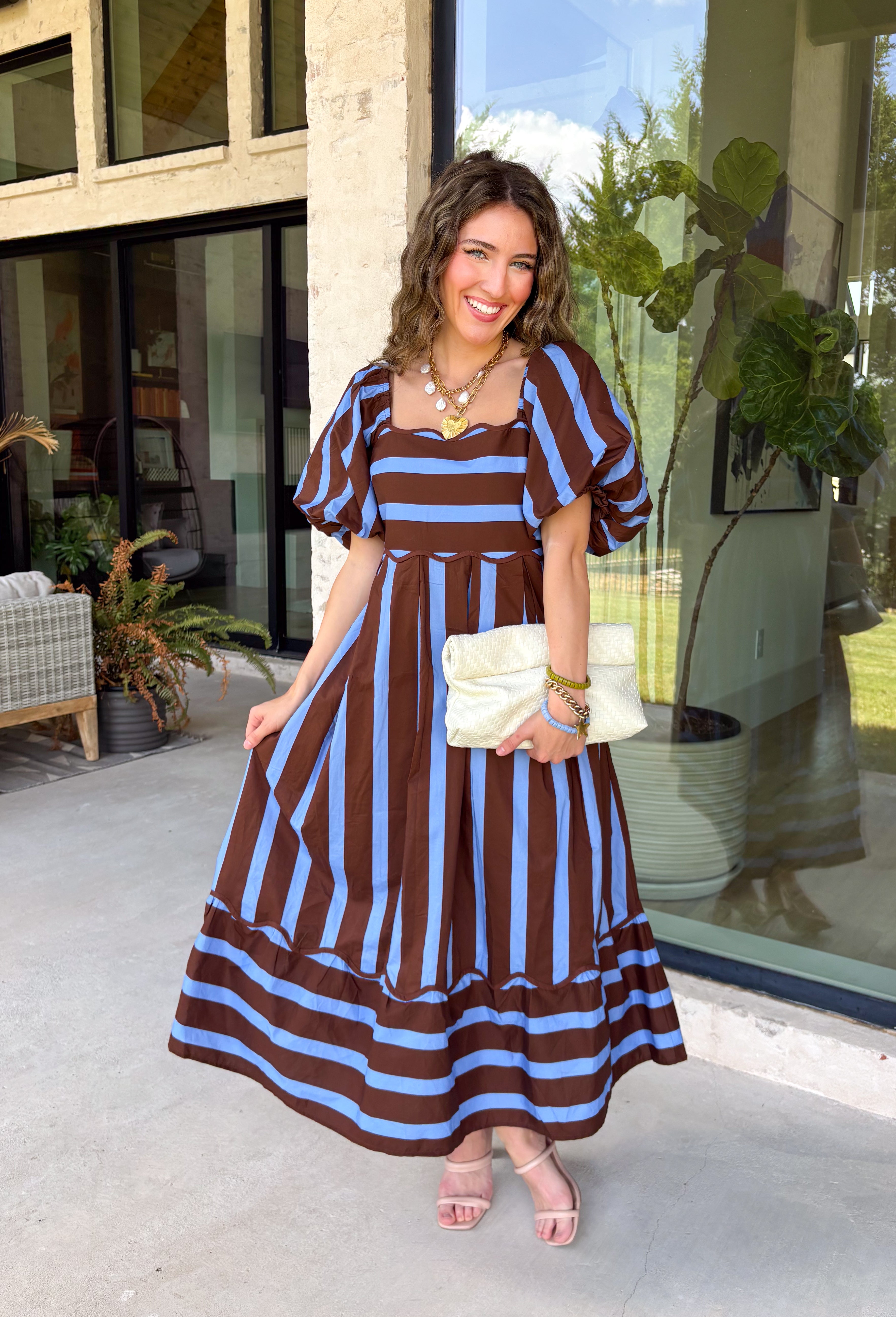 Brown and blue come together in the prettiest way on this striped midi dress from Entro. The scalloped square neckline gives the classic stripe print a sweet, unexpected touch, while short puff sleeves add just the right amount of shape. A smocked back creates a comfortable fit that moves with you, and convenient side pockets make this one even easier to love. 