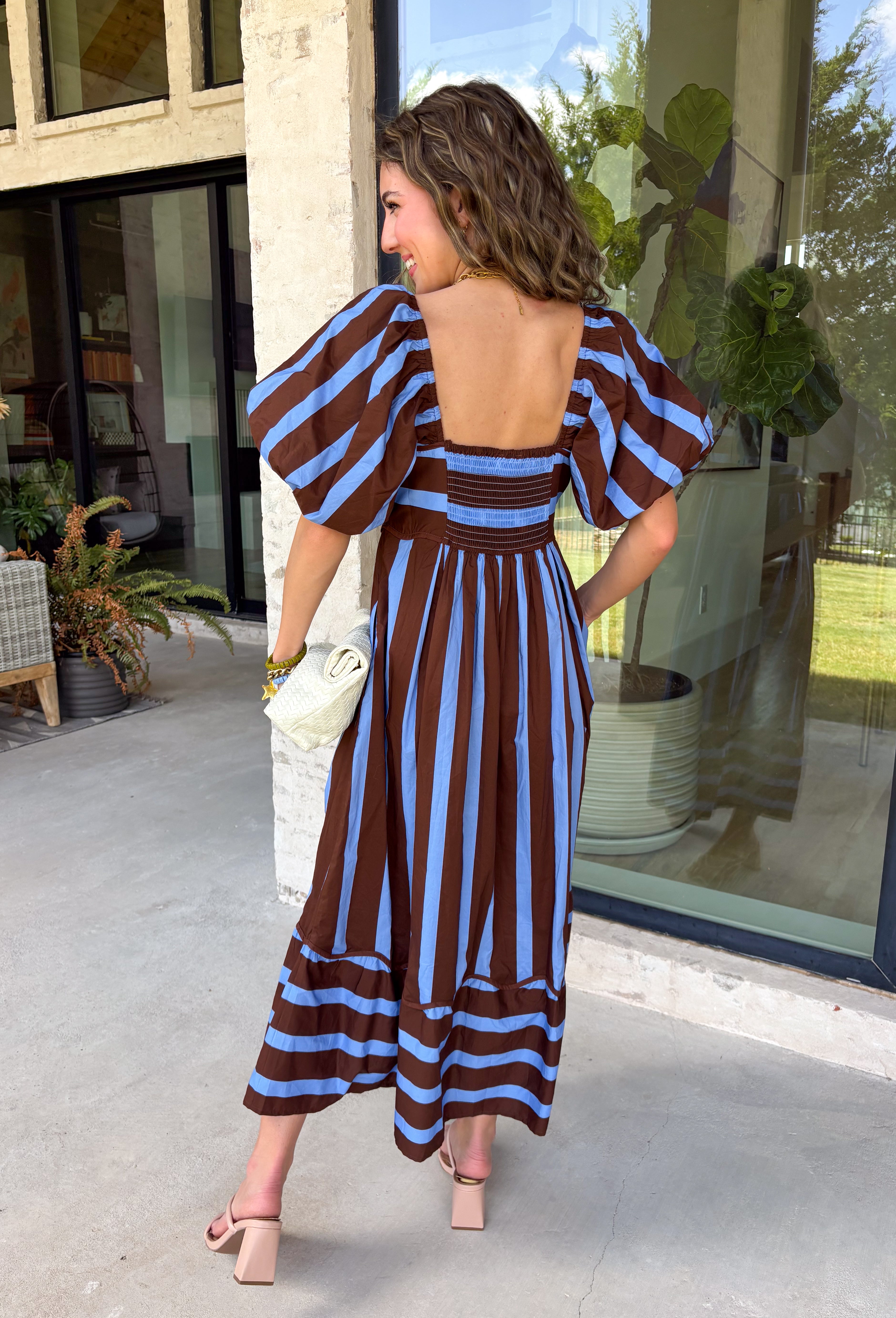 Brown and blue come together in the prettiest way on this striped midi dress from Entro. The scalloped square neckline gives the classic stripe print a sweet, unexpected touch, while short puff sleeves add just the right amount of shape. A smocked back creates a comfortable fit that moves with you, and convenient side pockets make this one even easier to love. 