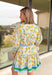 Fresh, bright, and effortlessly polished, this neutral long sleeve button-down dress is made for spring days when you want to feel put together without trying too hard. Featuring a yellow and blue floral print with pops of green, it brings the prettiest burst of color to a soft neutral base. Blue and green band detailing along the neckline and down the front adds a bold, flattering accent, with matching trim at the cuffs and hem for a pulled-together finish. 