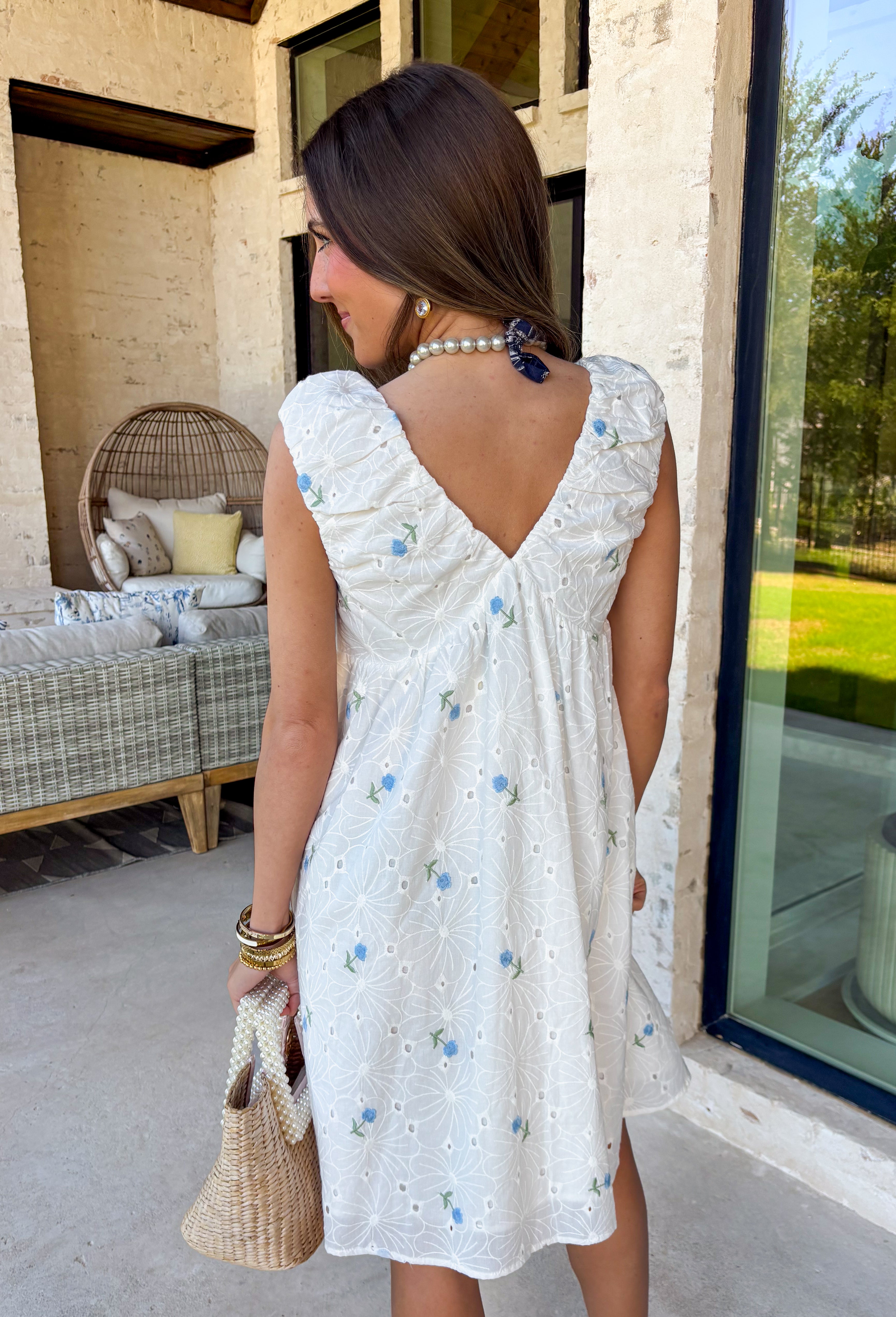 Light, airy, and made for sunny spring days, this white floral eyelet lace dress is as sweet as it gets. Dainty blue floral embroidery is scattered throughout, adding the prettiest pop of color against the crisp white backdrop. The eyelet lace texture gives it that timeless, feminine feel we all love this time of year. Designed with a flattering v-neckline and finished with a blue tassel tie detail, this dress blends charm and comfort effortlessly. 