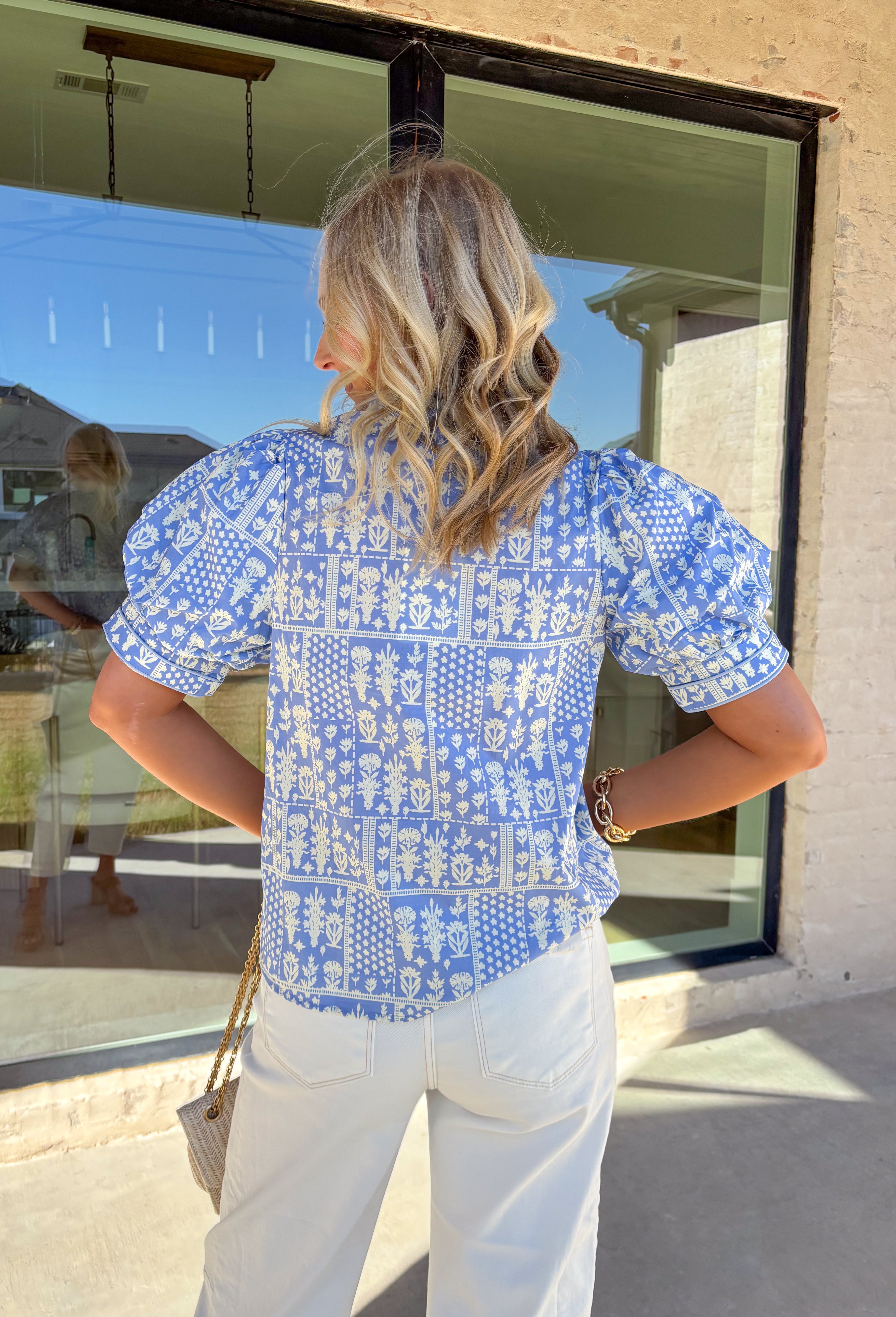 Fresh, pretty, and perfect for spring, this light blue top by Entro is an effortless favorite. Featuring an off-white patchwork floral print throughout, it brings a soft, charming vibe that’s easy to dress up or keep casual. Puff sleeves add a sweet, feminine touch, while the breathable cotton fabric keeps it lightweight and comfortable for warmer days ahead. This is one of those tops that instantly makes your outfit feel pulled together—without even trying.