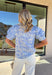 Fresh, pretty, and perfect for spring, this light blue top by Entro is an effortless favorite. Featuring an off-white patchwork floral print throughout, it brings a soft, charming vibe that’s easy to dress up or keep casual. Puff sleeves add a sweet, feminine touch, while the breathable cotton fabric keeps it lightweight and comfortable for warmer days ahead. This is one of those tops that instantly makes your outfit feel pulled together—without even trying.