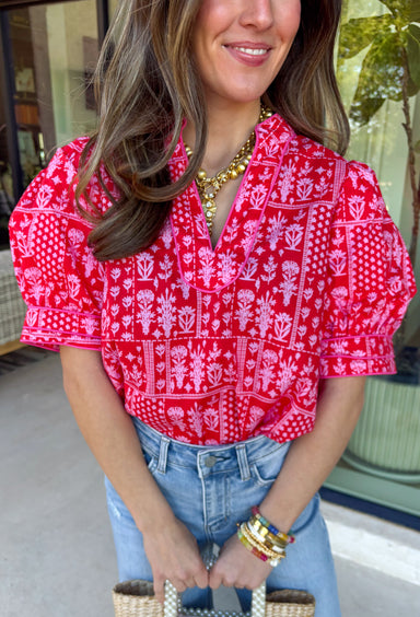 Fresh, pretty, and perfect for spring, this red top by Entro is an effortless favorite. Featuring a pink patchwork floral print throughout, it brings a soft, charming vibe that’s easy to dress up or keep casual. Puff sleeves add a sweet, feminine touch, while the breathable cotton fabric keeps it lightweight and comfortable for warmer days ahead. This is one of those tops that instantly makes your outfit feel pulled together—without even trying.