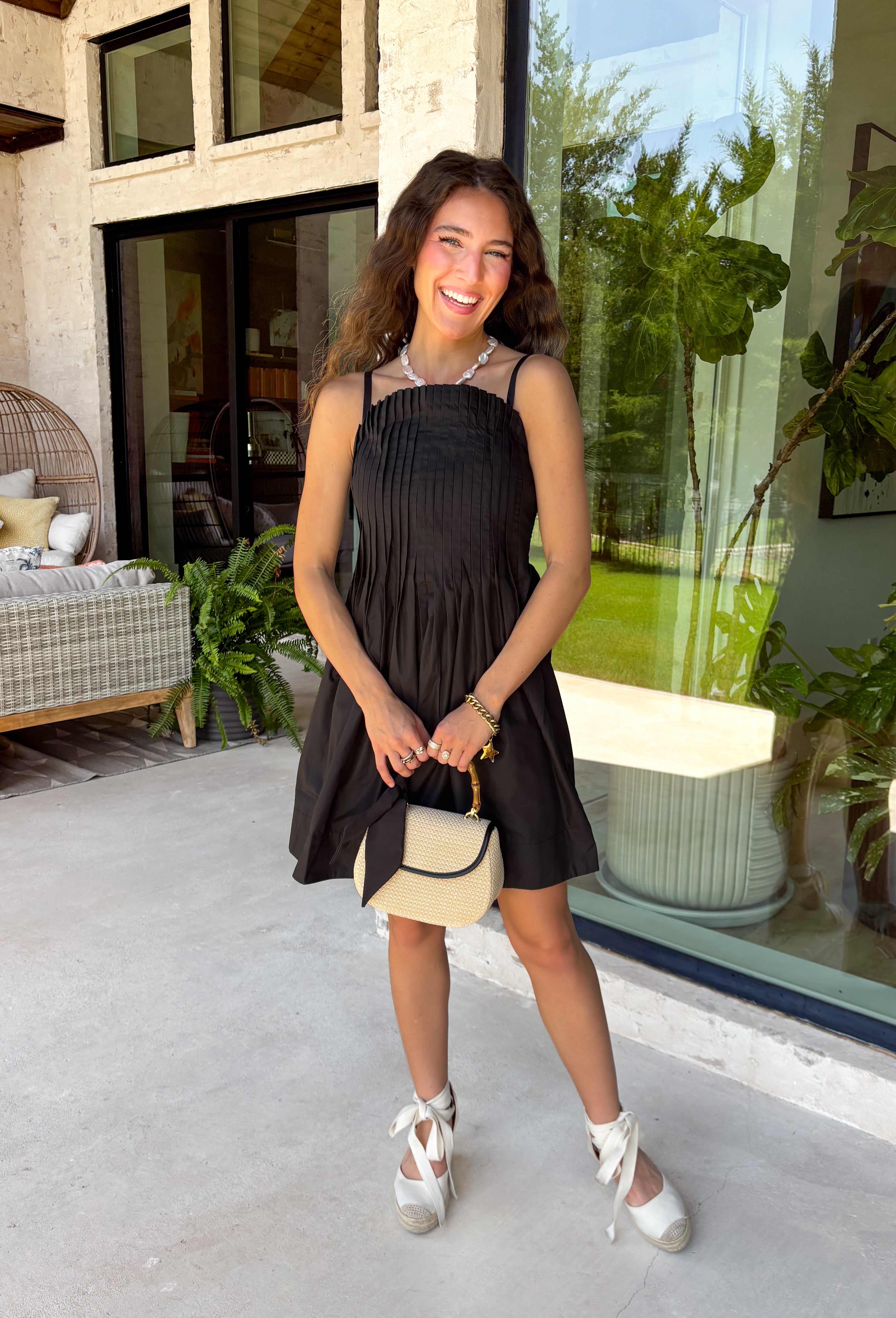 Every closet deserves a timeless little black dress, and this one is sure to become your new favorite! Designed with a flattering straight neckline and chic pleated bodice, this dress offers a polished look that's perfect for any occasion. Adjustable shoulder straps and a smocked back provide a comfortable, customizable fit, while side pockets add the practical detail everyone loves. 