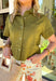 Easy, breezy, and effortlessly polished, this olive short sleeve button-down top by Entro is a spring staple you’ll wear on repeat. The ruffle neckline adds a soft, feminine touch to the classic button-down silhouette, while the front pocket detail keeps it casual and everyday-friendly. Made from a breathable cotton-linen blend, this top feels lightweight and airy—perfect for warm spring days, weekend plans, and everything in between.