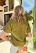Easy, breezy, and effortlessly polished, this olive short sleeve button-down top by Entro is a spring staple you’ll wear on repeat. The ruffle neckline adds a soft, feminine touch to the classic button-down silhouette, while the front pocket detail keeps it casual and everyday-friendly. Made from a breathable cotton-linen blend, this top feels lightweight and airy—perfect for warm spring days, weekend plans, and everything in between.