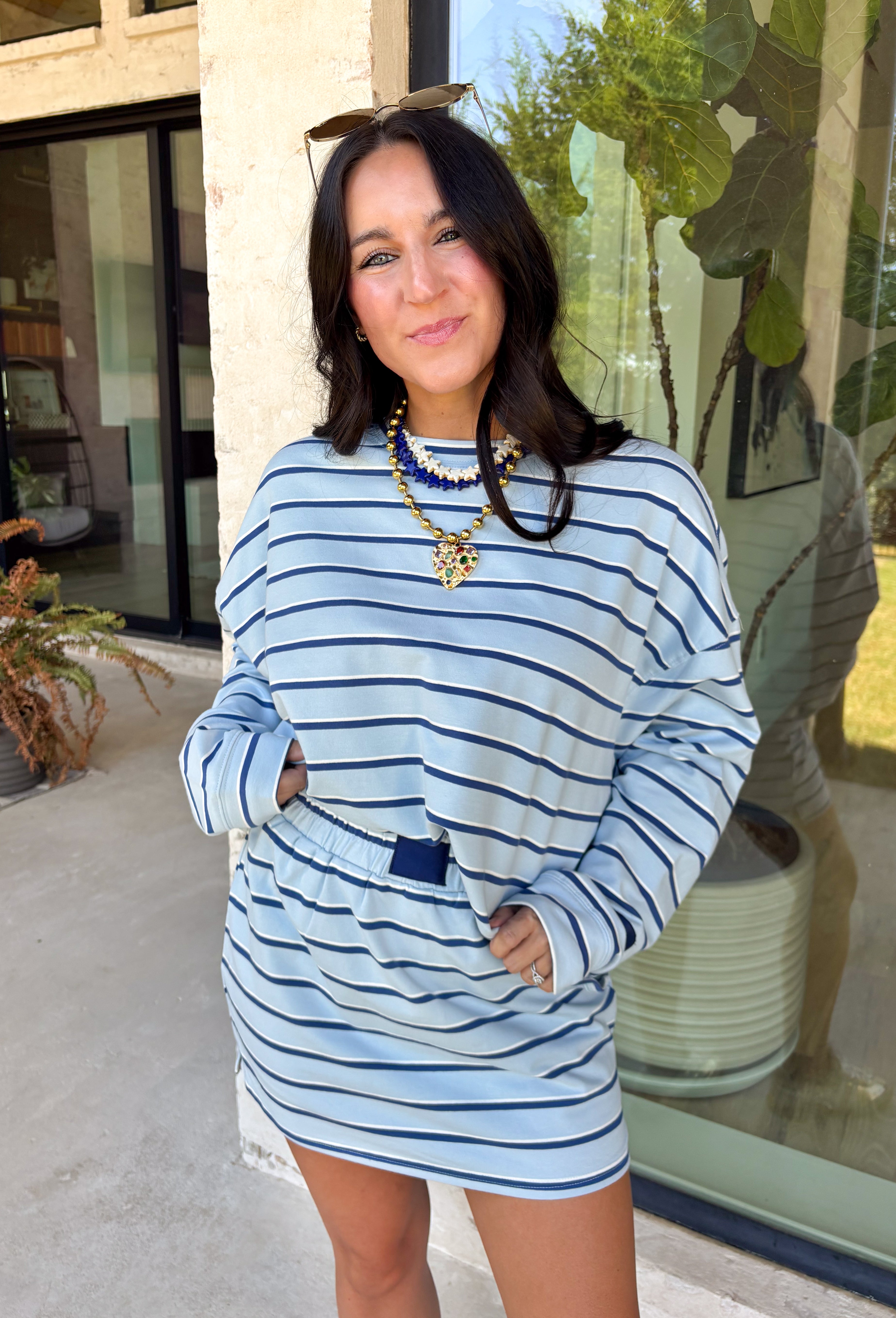 Classic stripes get a fresh update with this long sleeve top from Day + Moon. The light blue base is paired with navy and white stripes for a crisp color combination that’s easy to wear throughout the season. Made from a soft cotton blend with a touch of stretch, it keeps you comfortable whether you’re heading to work, running errands, or making weekend plans. 