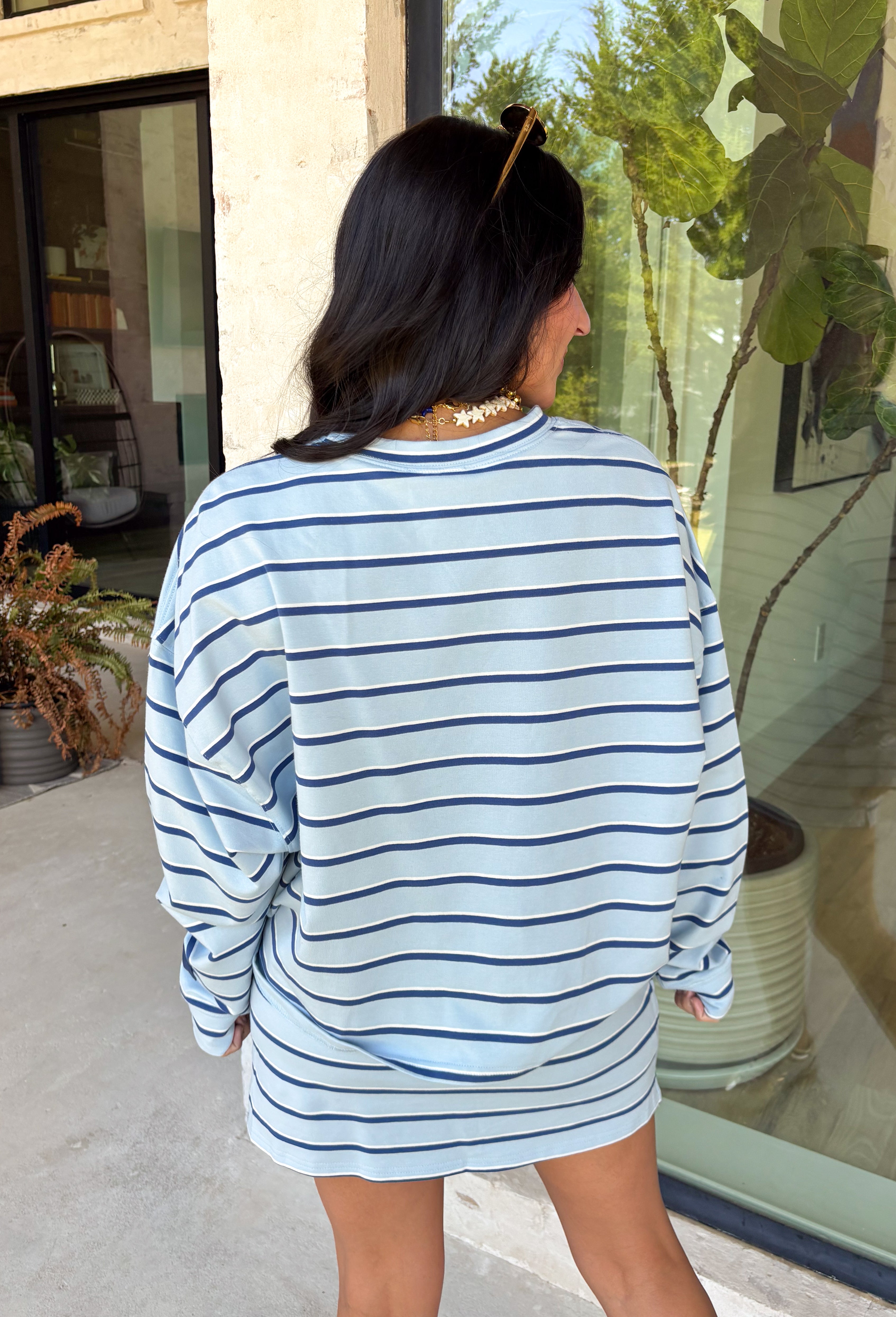 Classic stripes get a fresh update with this long sleeve top from Day + Moon. The light blue base is paired with navy and white stripes for a crisp color combination that’s easy to wear throughout the season. Made from a soft cotton blend with a touch of stretch, it keeps you comfortable whether you’re heading to work, running errands, or making weekend plans. 