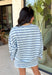 Classic stripes get a fresh update with this long sleeve top from Day + Moon. The light blue base is paired with navy and white stripes for a crisp color combination that’s easy to wear throughout the season. Made from a soft cotton blend with a touch of stretch, it keeps you comfortable whether you’re heading to work, running errands, or making weekend plans. 