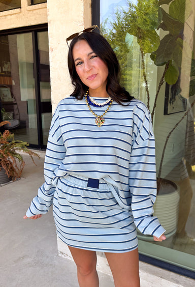 Classic stripes get a fresh update with this long sleeve top from Day + Moon. The light blue base is paired with navy and white stripes for a crisp color combination that’s easy to wear throughout the season. Made from a soft cotton blend with a touch of stretch, it keeps you comfortable whether you’re heading to work, running errands, or making weekend plans. 