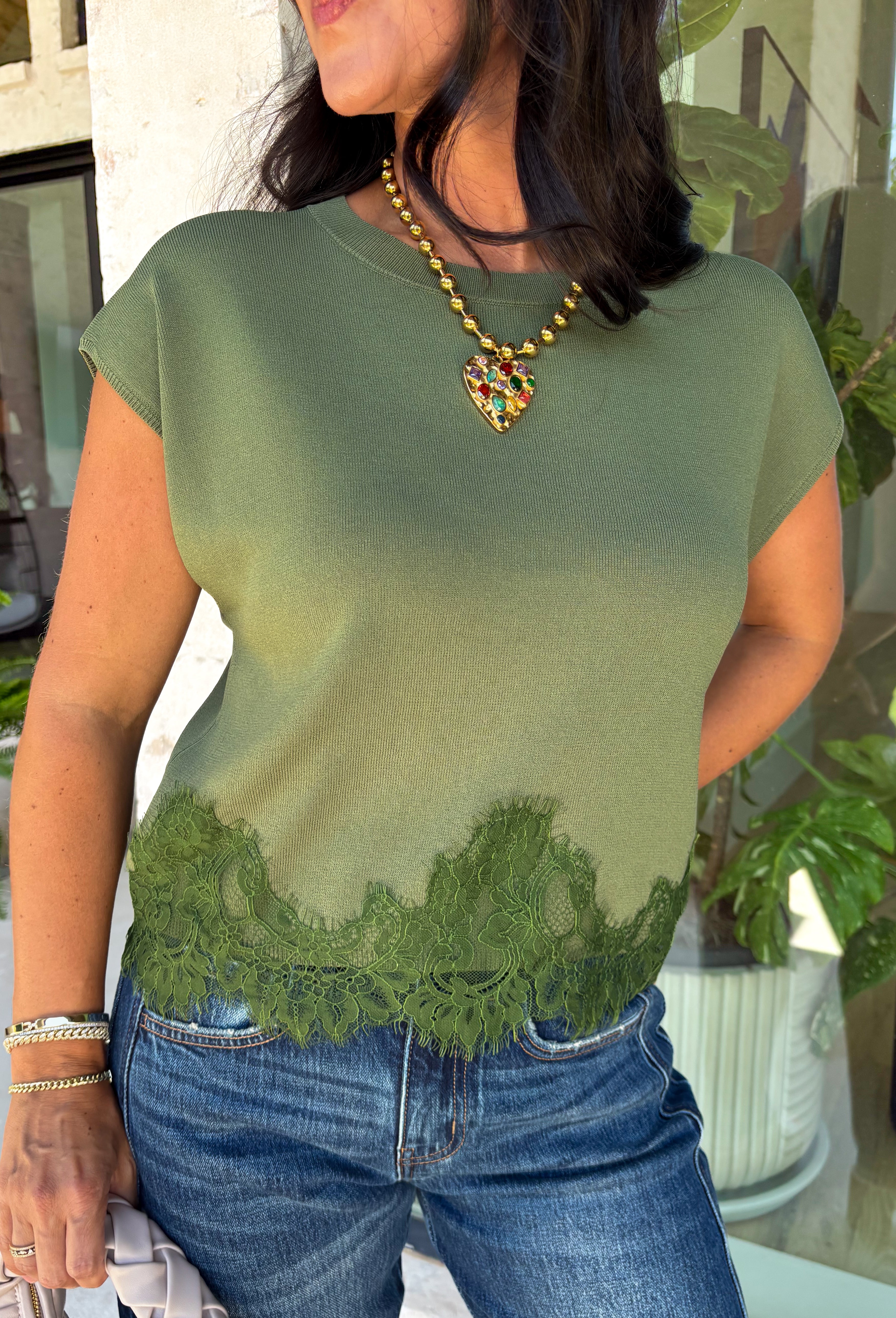 A cozy knit with feminine details is always a fall favorite! This olive short sleeve sweater is the perfect combination of timeless style and everyday comfort. The soft sweater knit feels cozy without being bulky, while the cap sleeves make it ideal for layering under jackets and cardigans throughout the season. Delicate lace trim along the hem adds a beautiful finishing touch, giving this classic piece an elevated feel.