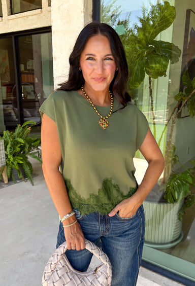 A cozy knit with feminine details is always a fall favorite! This olive short sleeve sweater is the perfect combination of timeless style and everyday comfort. The soft sweater knit feels cozy without being bulky, while the cap sleeves make it ideal for layering under jackets and cardigans throughout the season. Delicate lace trim along the hem adds a beautiful finishing touch, giving this classic piece an elevated feel.