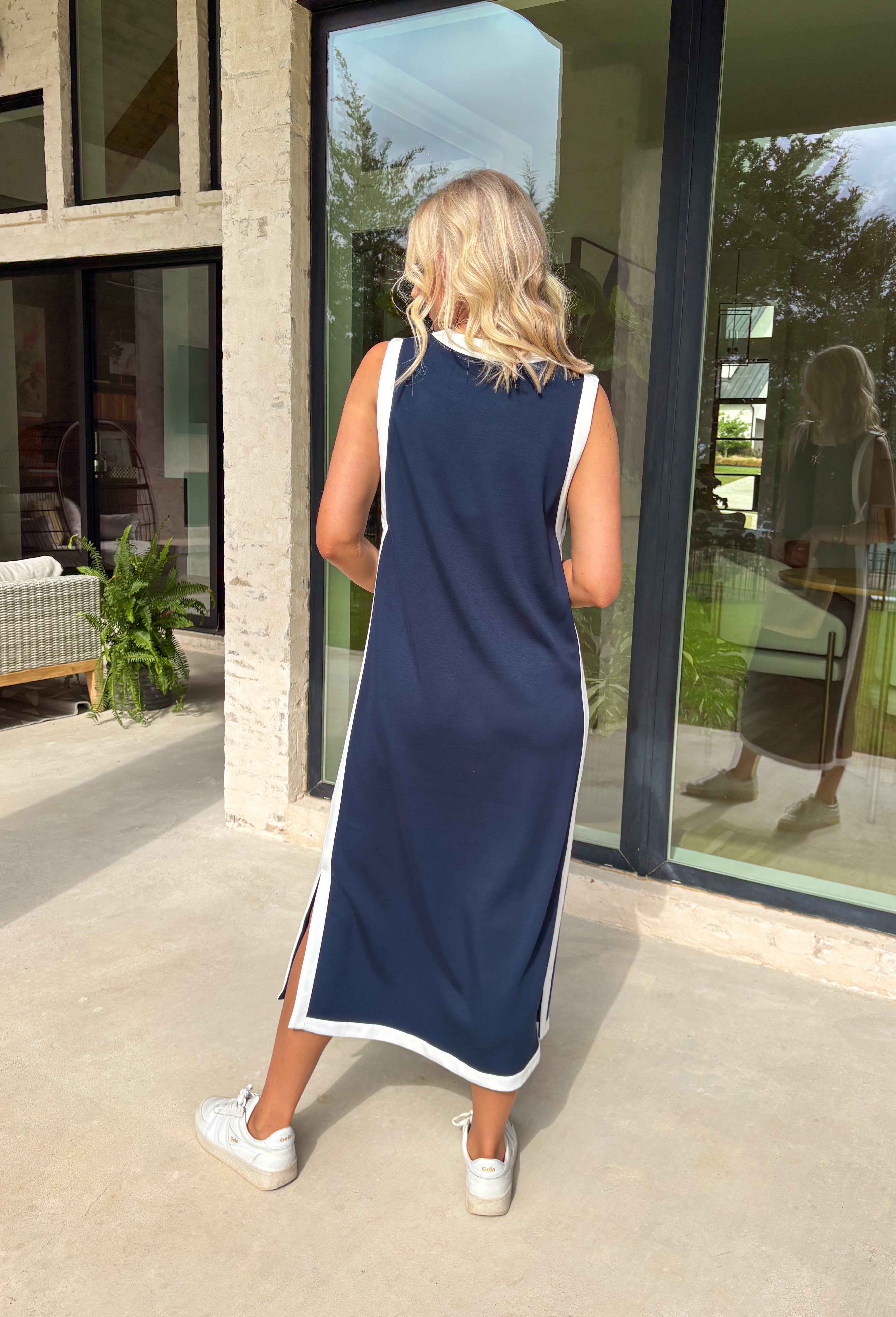 Sleek, simple, and effortlessly chic, this navy sleeveless midi dress by Entro is a fresh spring staple you’ll wear on repeat. Designed with crisp white contrast binding along the neckline, armholes, and hem, it offers a polished look with just the right amount of edge. A side slit adds easy movement, while the lightweight, soft fabric blend keeps it comfortable for warm spring days and breezy evenings.