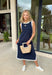 Sleek, simple, and effortlessly chic, this navy sleeveless midi dress by Entro is a fresh spring staple you’ll wear on repeat. Designed with crisp white contrast binding along the neckline, armholes, and hem, it offers a polished look with just the right amount of edge. A side slit adds easy movement, while the lightweight, soft fabric blend keeps it comfortable for warm spring days and breezy evenings.