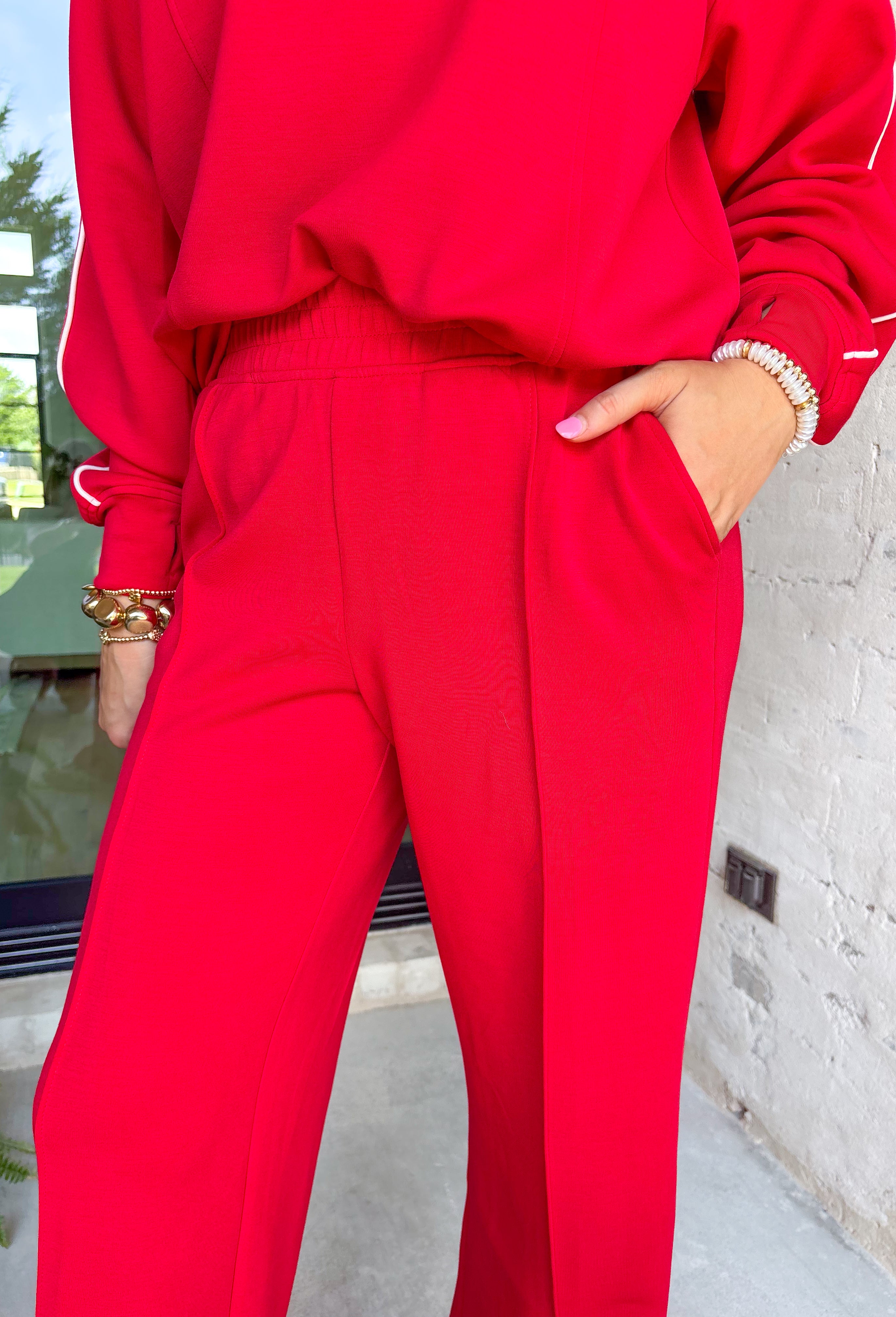 Laid-back comfort meets bold style in these red wide leg pants. Designed with a seam down the front for a flattering touch, they feature an easy elastic waistband that keeps the fit relaxed yet polished. Cozy in a soft modal-blend fabric, these pants are perfect for lounging, running errands, or styling up for a night out. Pair with the matching Point Taken Pullover in Red to wear as a set, or mix and match with your favorite tops for endless outfit possibilities.