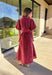 Get ready to celebrate in style with this red plaid midi dress by Entro. Designed with puff sleeves and a button-front closure, it’s both classic and festive. A self-tie waist belt cinches the shape for a flattering fit, while side pockets and a soft lining keep it practical and comfortable. With its cheerful plaid pattern and timeless silhouette, this dress is the perfect choice for holiday gatherings and seasonal events.