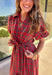 Get ready to celebrate in style with this red plaid midi dress by Entro. Designed with puff sleeves and a button-front closure, it’s both classic and festive. A self-tie waist belt cinches the shape for a flattering fit, while side pockets and a soft lining keep it practical and comfortable. With its cheerful plaid pattern and timeless silhouette, this dress is the perfect choice for holiday gatherings and seasonal events.