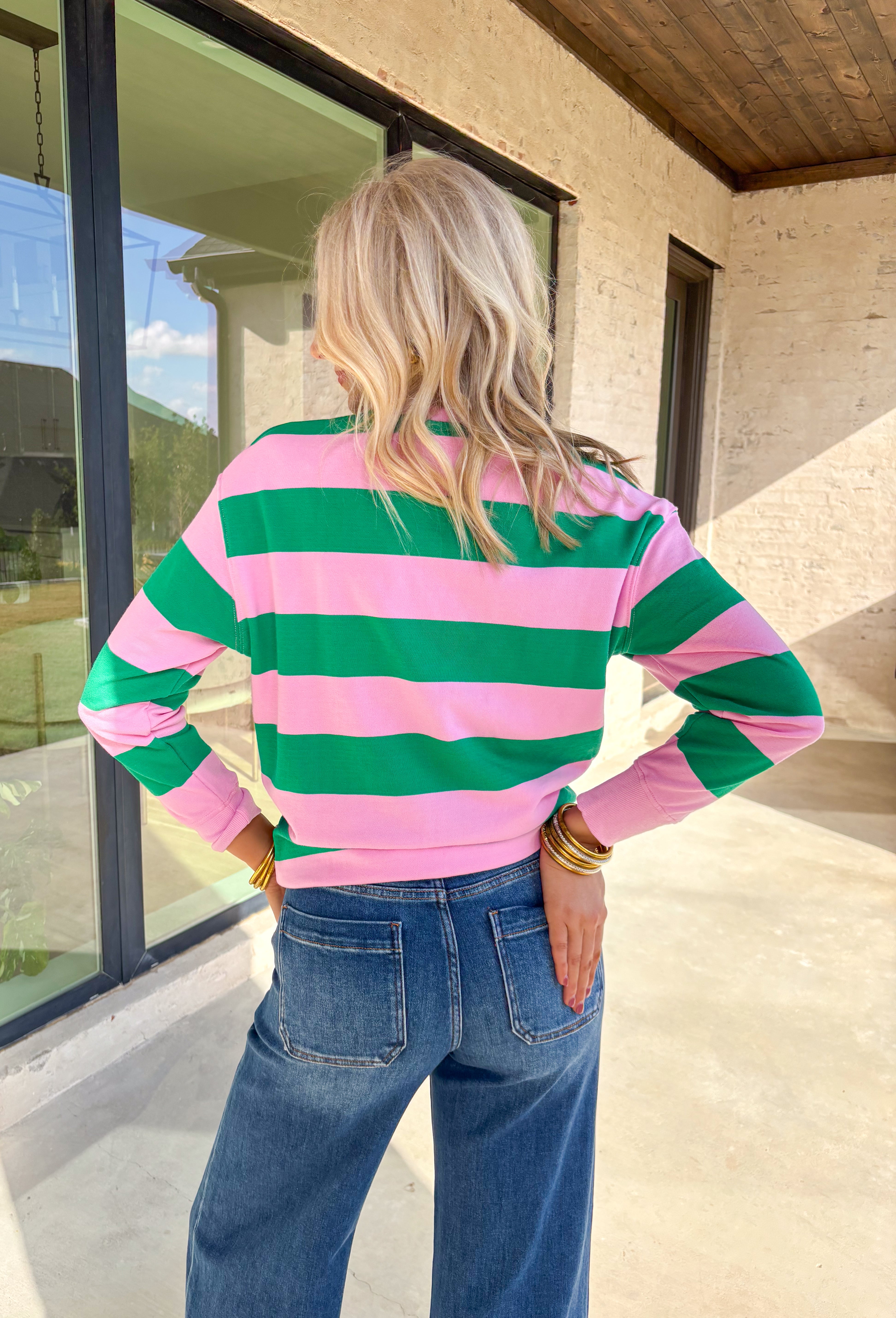 Bring a little merry to your winter wardrobe with this playful “Holly Jolly” pullover by Shiraleah! Designed in pink and green stripes with festive red embroidery across the front, this cozy sweatshirt is equal parts cute and comfortable. Whether you’re wrapping gifts, sipping cocoa, or heading to a holiday get-together, this cheerful piece keeps the spirit bright all season long.