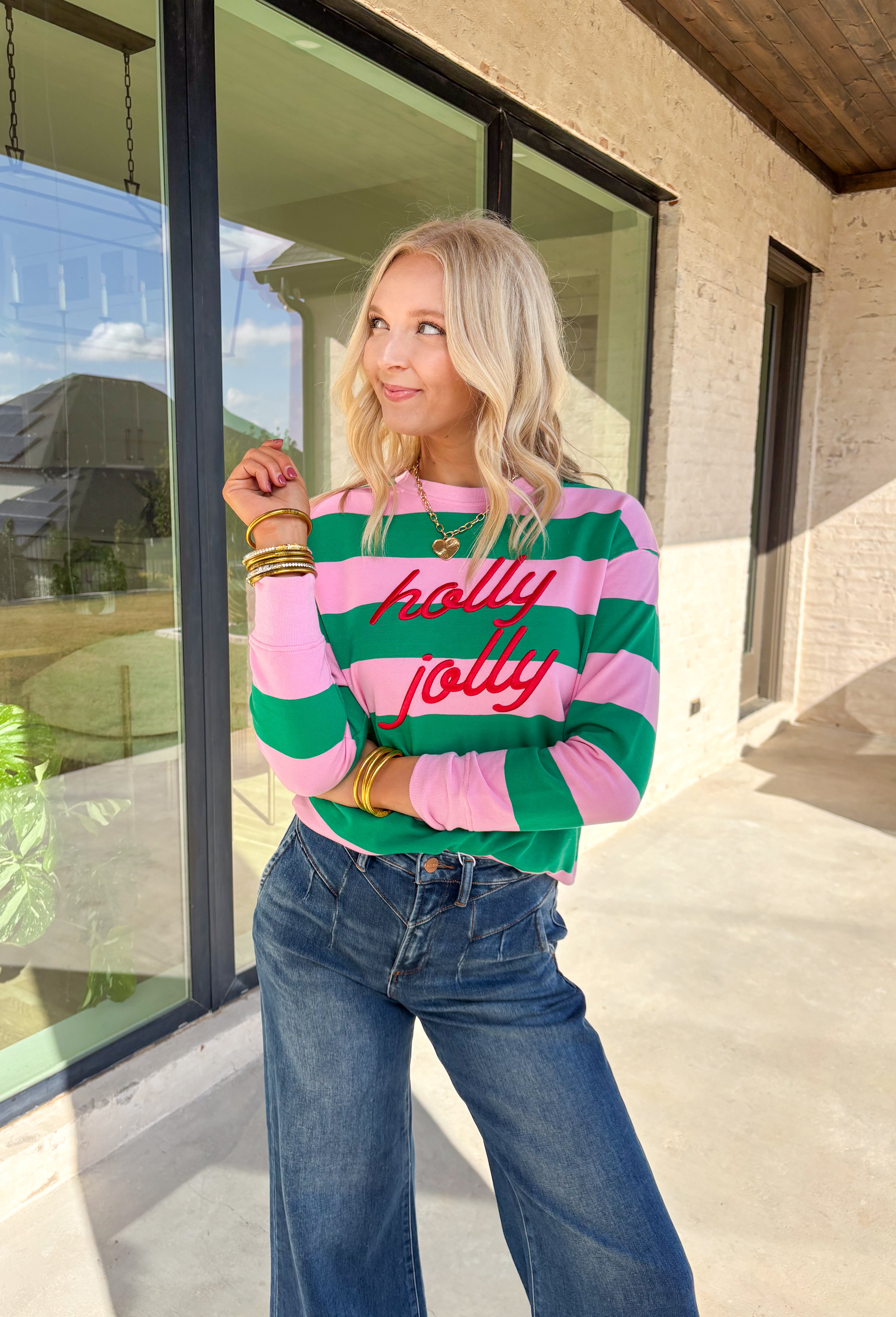 Bring a little merry to your winter wardrobe with this playful “Holly Jolly” pullover by Shiraleah! Designed in pink and green stripes with festive red embroidery across the front, this cozy sweatshirt is equal parts cute and comfortable. Whether you’re wrapping gifts, sipping cocoa, or heading to a holiday get-together, this cheerful piece keeps the spirit bright all season long.