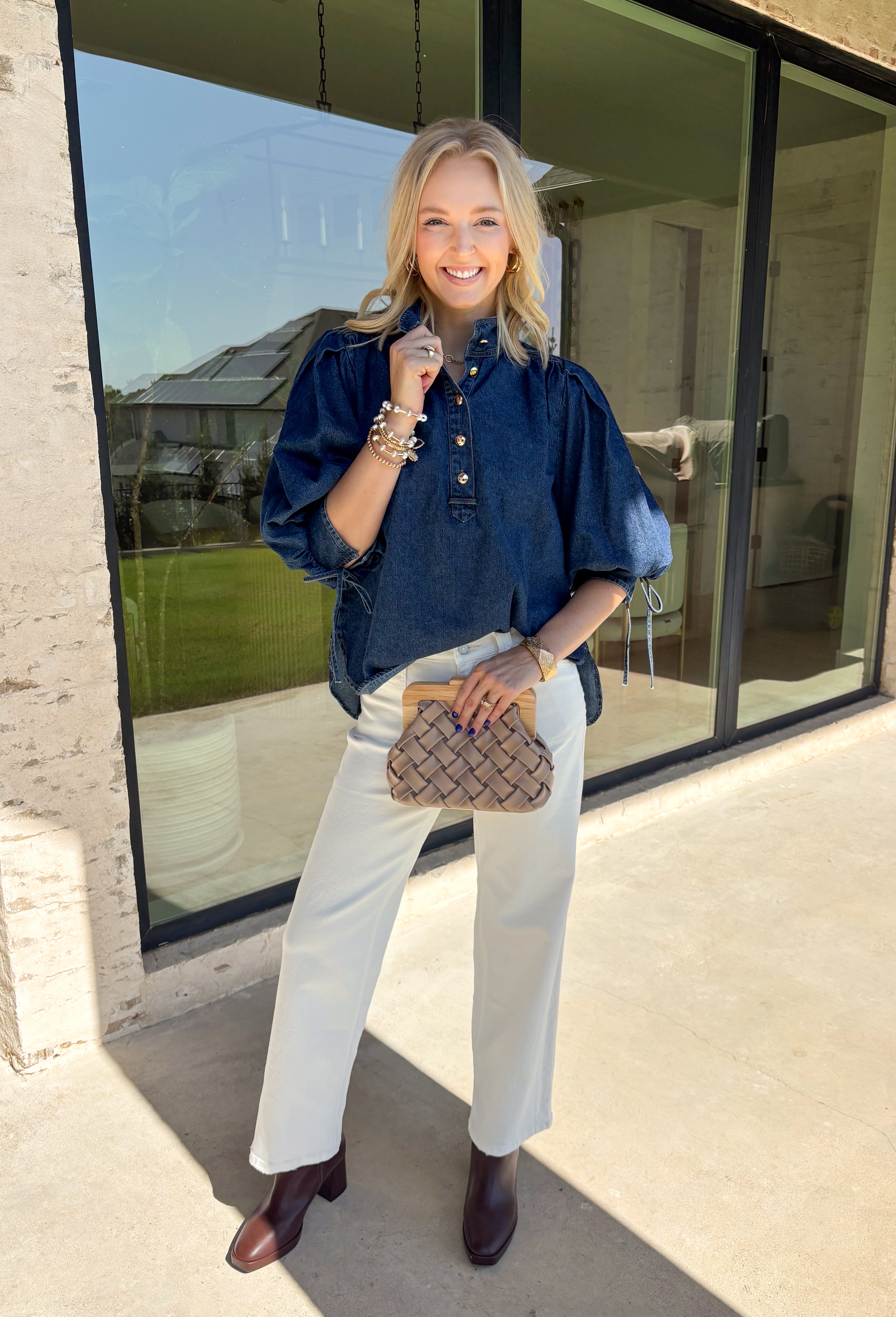 A classic denim top is a wardrobe staple, and this beautifully detailed top from Entro is one you'll wear on repeat. Designed in a rich dark wash denim, this timeless piece features a gold button-front design that makes it easy to style for any occasion. The ¾ puff sleeves add a feminine touch, while the self-tie cuffs create a charming finishing detail.