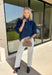 A classic denim top is a wardrobe staple, and this beautifully detailed top from Entro is one you'll wear on repeat. Designed in a rich dark wash denim, this timeless piece features a gold button-front design that makes it easy to style for any occasion. The ¾ puff sleeves add a feminine touch, while the self-tie cuffs create a charming finishing detail.