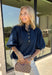 A classic denim top is a wardrobe staple, and this beautifully detailed top from Entro is one you'll wear on repeat. Designed in a rich dark wash denim, this timeless piece features a gold button-front design that makes it easy to style for any occasion. The ¾ puff sleeves add a feminine touch, while the self-tie cuffs create a charming finishing detail.