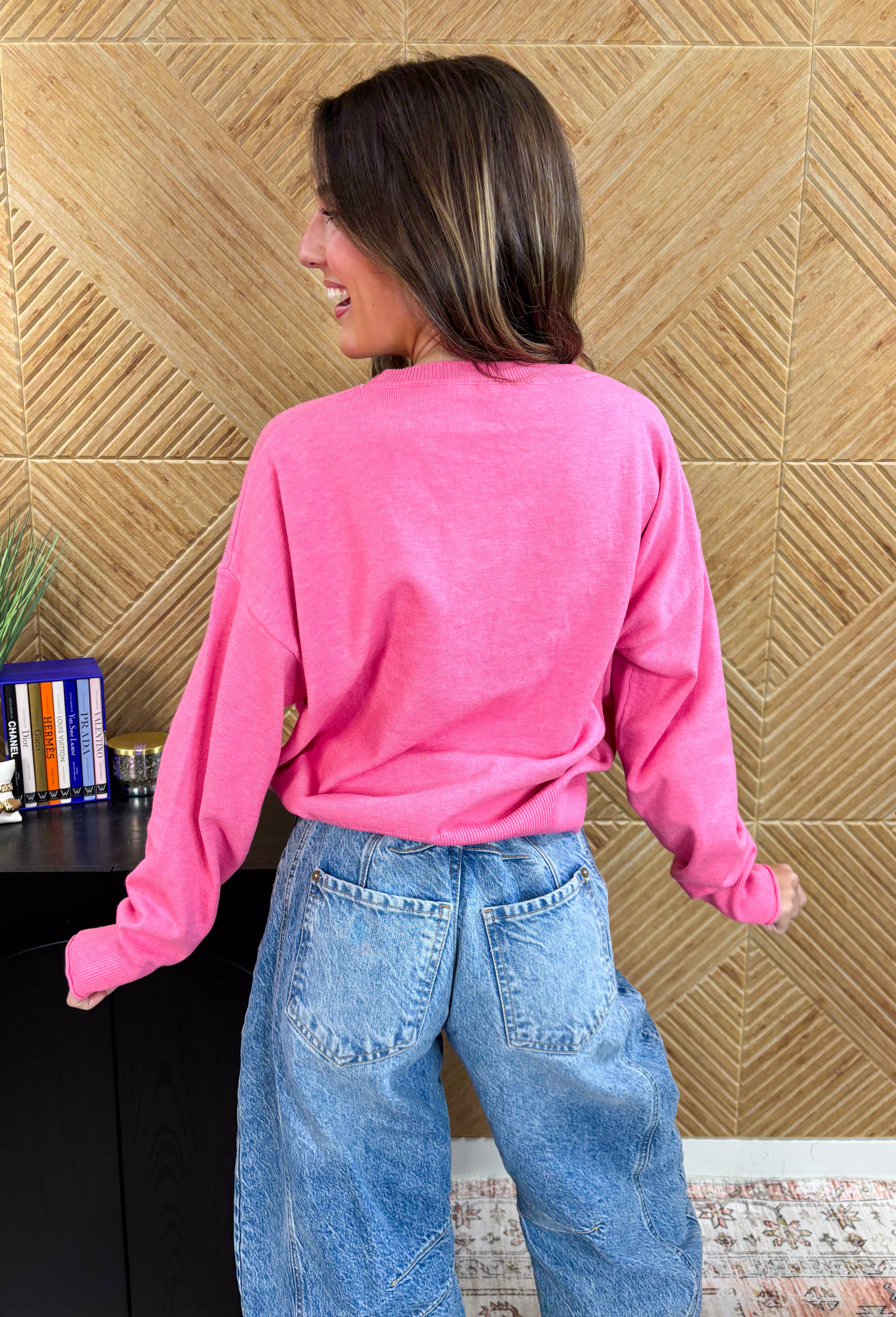 Bring the festive fun with this adorable pink holiday sweater by Sunday Edition! Featuring a white slug bug design complete with a Christmas tree hanging out the back, presents stacked on top, and colorful string lights along the side, this playful knit captures all the magic of the season. Soft, cozy, and full of charm, it’s the perfect sweater for cookie decorating, holiday parties, or any moment that needs a little extra cheer.