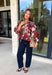 Deep merlot brings a rich seasonal feel to this floral top from Entro. The neutral floral print softens the bold background with warm, easy-to-style shades that fit beautifully into a late-fall wardrobe. A high neckline and button-front closure give the top a classic look, while contrast trim adds another eye-catching detail. The ¾ puff sleeves are finished with buttoned cuffs, and gathering along the back yoke adds subtle shape and movement. 