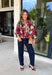 Deep merlot brings a rich seasonal feel to this floral top from Entro. The neutral floral print softens the bold background with warm, easy-to-style shades that fit beautifully into a late-fall wardrobe. A high neckline and button-front closure give the top a classic look, while contrast trim adds another eye-catching detail. The ¾ puff sleeves are finished with buttoned cuffs, and gathering along the back yoke adds subtle shape and movement. 